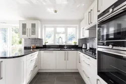 White kitchen design with dark countertops