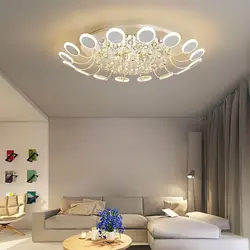 Suspended ceiling with spotlights and chandelier in the living room photo