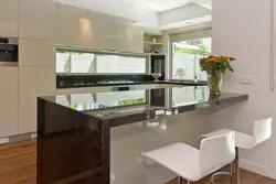 Kitchen design in a modern style in light colors with bar