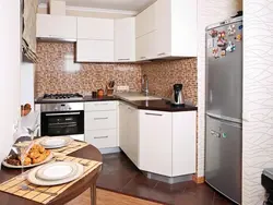 Kitchen in a small apartment photo with refrigerator design