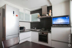 Corner kitchen design with refrigerator, household appliances photo