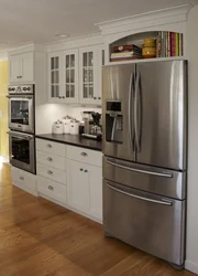 Corner kitchen design with refrigerator, household appliances photo