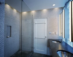 Doors to the bathroom and toilet in the interior photo