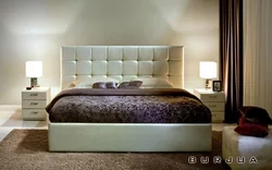 Photo of a bedroom with a soft headboard