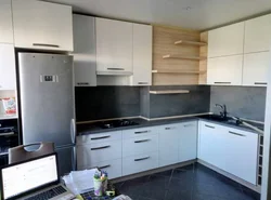 Photo of a kitchen with a ventilation duct in the corner photo
