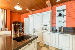 Kitchens on one wall in a wooden house photo