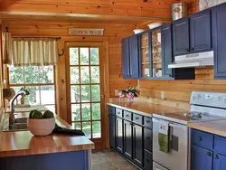 Kitchens on one wall in a wooden house photo
