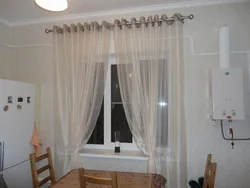 Curtains for the kitchen in the interior of the apartment