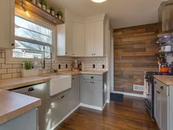 Wallpaper in the interior of a white kitchen with wood