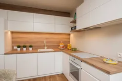 Wallpaper in the interior of a white kitchen with wood