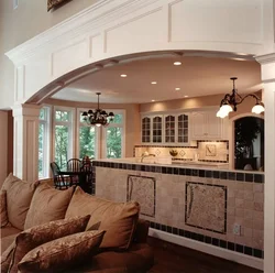 Arches in the interior of the living room with kitchen photo