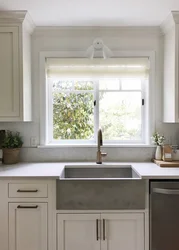 Kitchen with sink by the window in the house interior