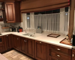Kitchen with sink by the window in the house interior