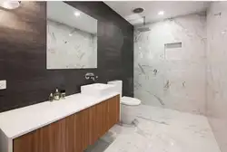 Bath design with marble tiles and wood