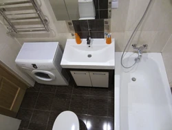 Bathroom Interior With Small Bathtub And Washing Machine