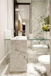 Small bathroom in marble tiles photo