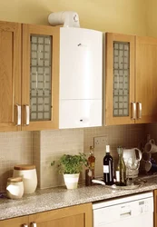 Photo of a kitchen with a gas boiler on the wall and pipes