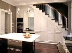 Kitchen In A House With Stairs To The Second Floor Design Photo