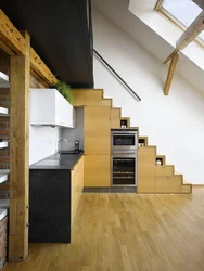 Kitchen in a house with stairs to the second floor design photo