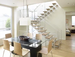 Kitchen In A House With Stairs To The Second Floor Design Photo