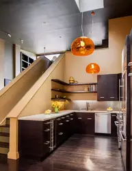 Kitchen in a house with stairs to the second floor design photo