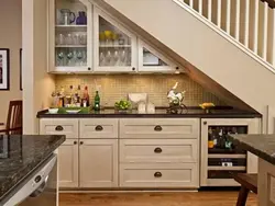 Kitchen In A House With Stairs To The Second Floor Design Photo