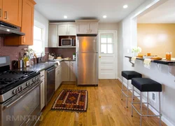 Walk-through kitchen design with a window and two doors