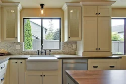 Walk-through kitchen design with a window and two doors