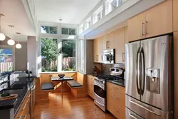 Walk-Through Kitchen Design With A Window And Two Doors