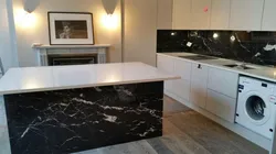 Photo of a kitchen with a black countertop and apron photo