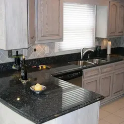 Photo Of A Kitchen With A Black Countertop And Apron Photo