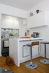 Kitchen with a bar counter in a studio 25 sq m photo