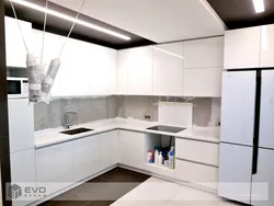 Interior of a white glossy corner kitchen