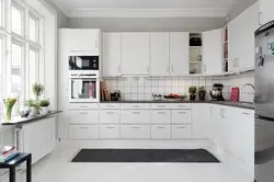 Interior of a white glossy corner kitchen