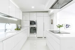 Interior of a white glossy corner kitchen