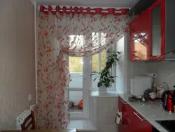 Photo of curtains on a kitchen window with an exit