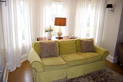 Sofa by the window in the living room photo in modern style