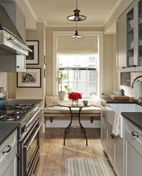 Narrow kitchen design with window at end and door
