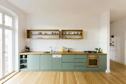 Green kitchen with wooden countertops in the interior