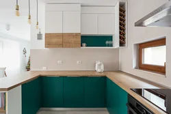 Green kitchen with wooden countertops in the interior