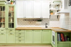 Green kitchen with wooden countertops in the interior