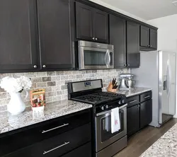 Kitchen design with black countertop and splashback