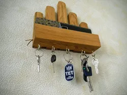 Key holders in the hallway photo wall made of wood