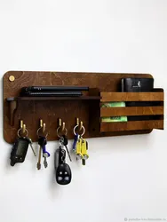 Key holders in the hallway photo wall made of wood
