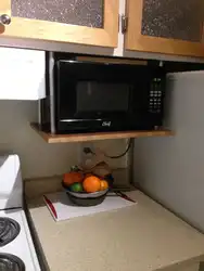 Microwave on brackets in the kitchen photo