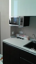 Microwave on brackets in the kitchen photo