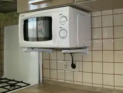 Microwave on brackets in the kitchen photo
