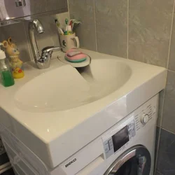 Washing Machine Under The Sink In The Bathroom Photo