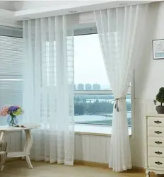 Design of curtains for a window with a balcony in the living room