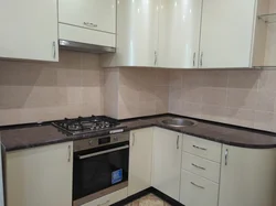 Kitchen design in a panel house with a ventilation duct